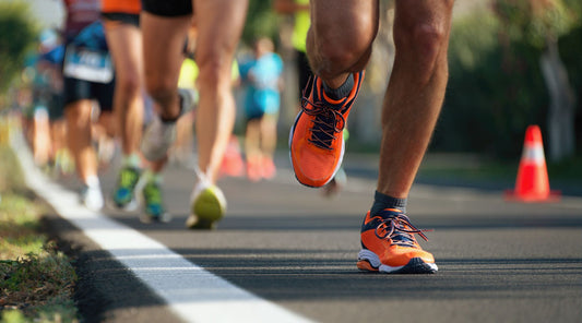 Läufer bei Straßenlauf mit Fokus auf Laufschuhe